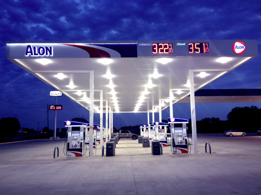 Gas station at night with illuminated lights.