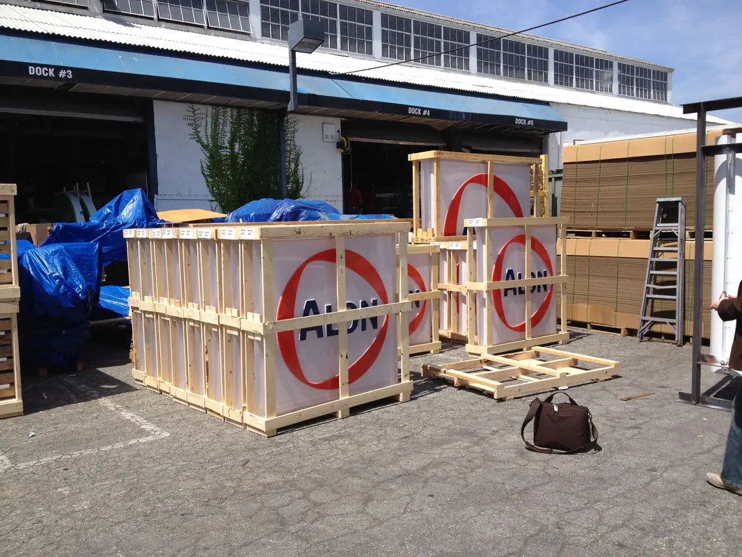 Crates with signs outside industrial building.