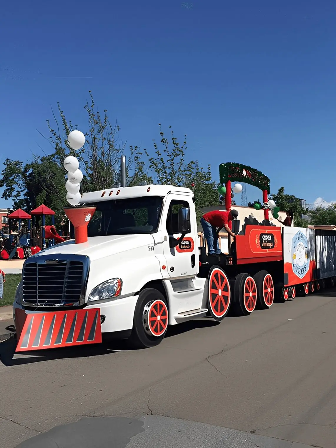Decorative train-themed truck on street.